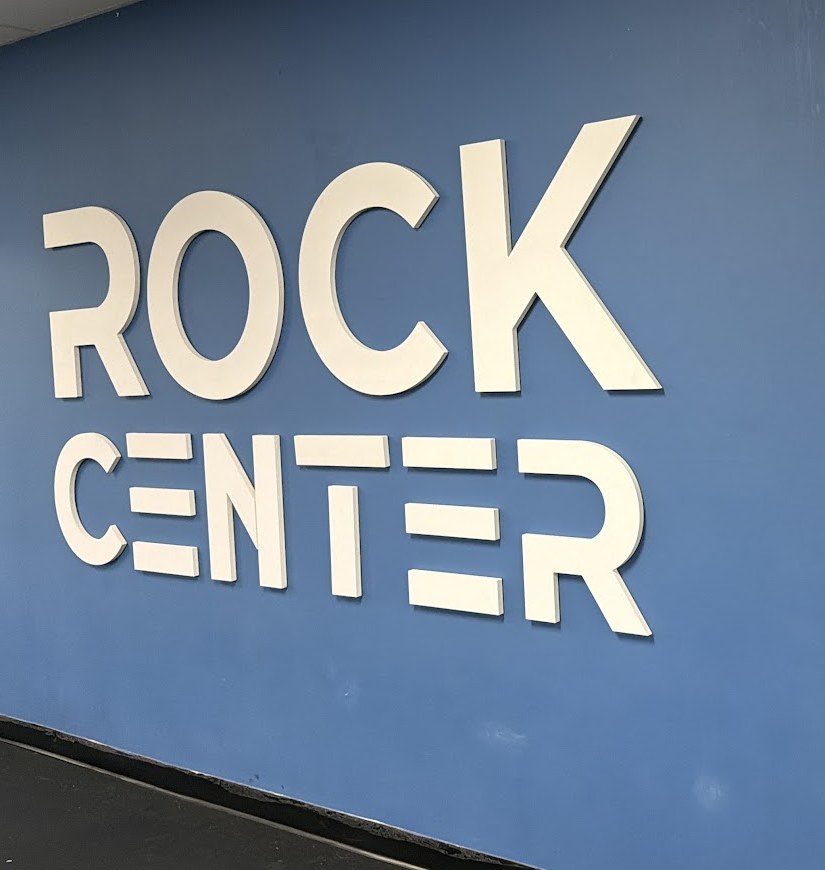 The Rock Center feature wall, royal blue with white ROCK CENTER lettering